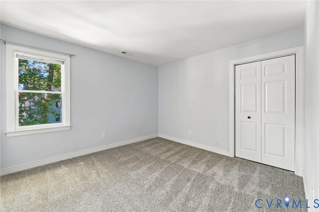 4712 Cedar Forest Road, Glen Allen, VA 23060 Bedroom 3 with neutral new carpeting, closet, and views of the surrounding greenery.