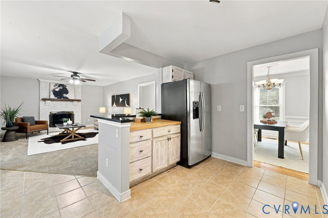 4712 Cedar Forest Road, Glen Allen, VA 23060 Open kitchen layout overlooking the family room with a brick fireplace, creating a comfortable space for everyday living and entertaining.