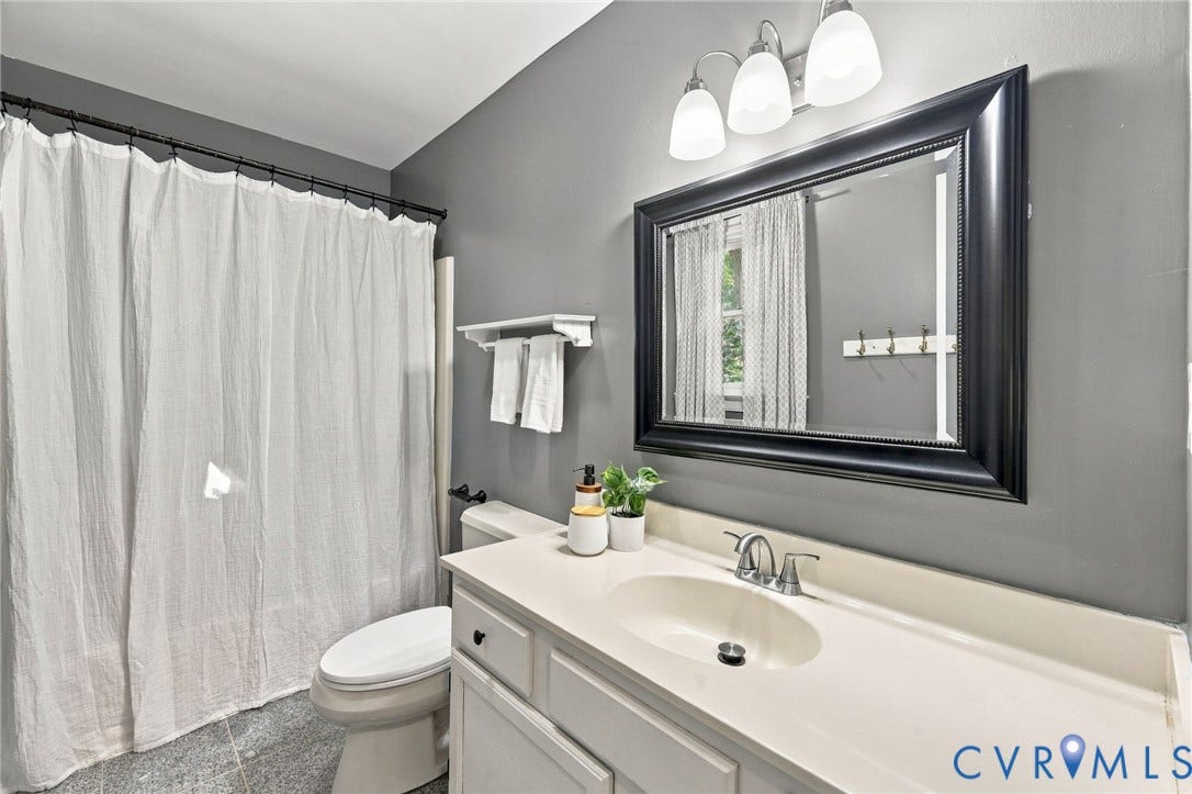 4712 Cedar Forest Road, Glen Allen, VA 23060 Full hall bathroom featuring a spacious vanity, tub/shower combination, and updated light fixture.