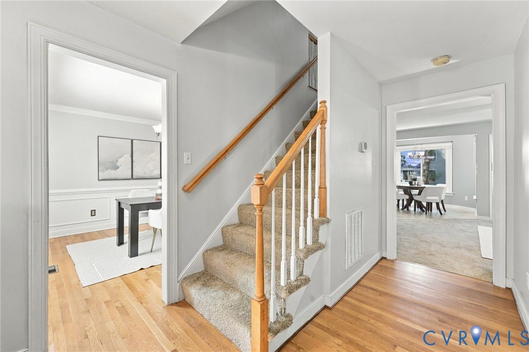 4712 Cedar Forest Road, Glen Allen, VA 23060 Spacious foyer with hardwood flooring and a central staircase with brand new carpet connecting the home's main living areas.