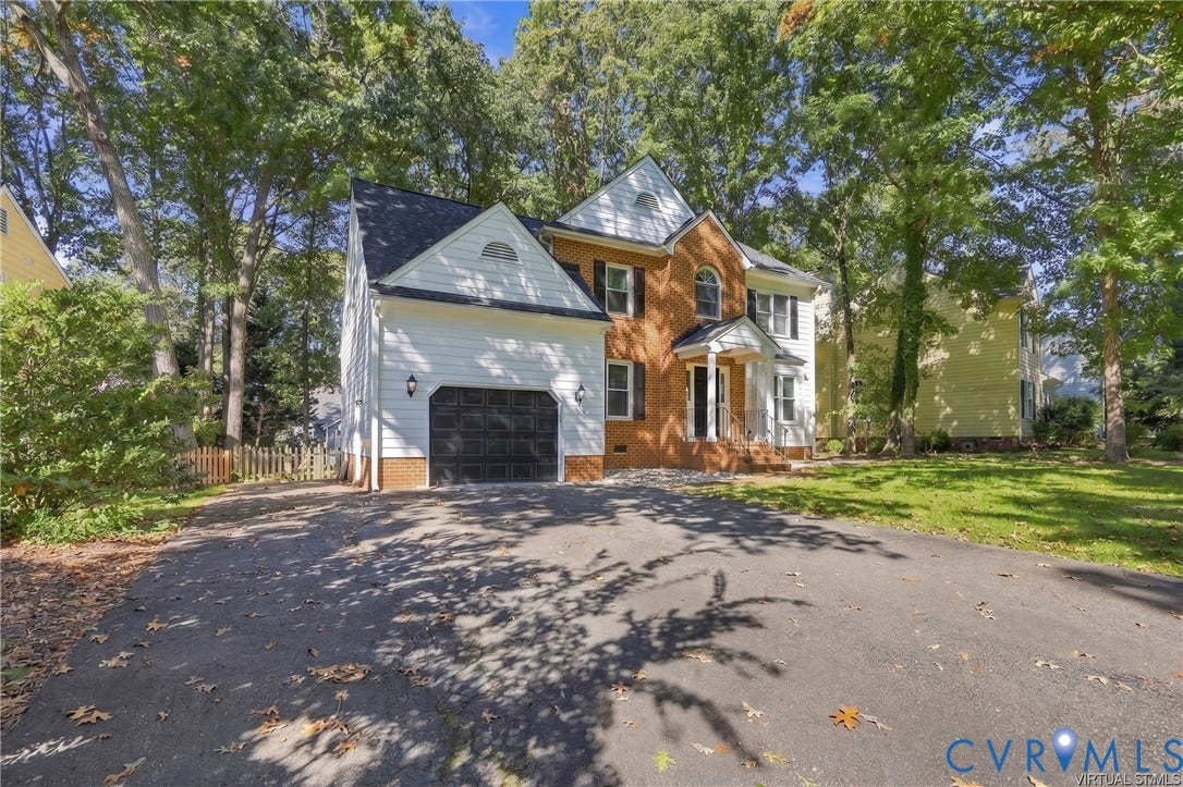 4712 Cedar Forest Road, Glen Allen, VA 23060 This home provides an attached garage with paved double width driveway offering convenient parking and additional storage space.