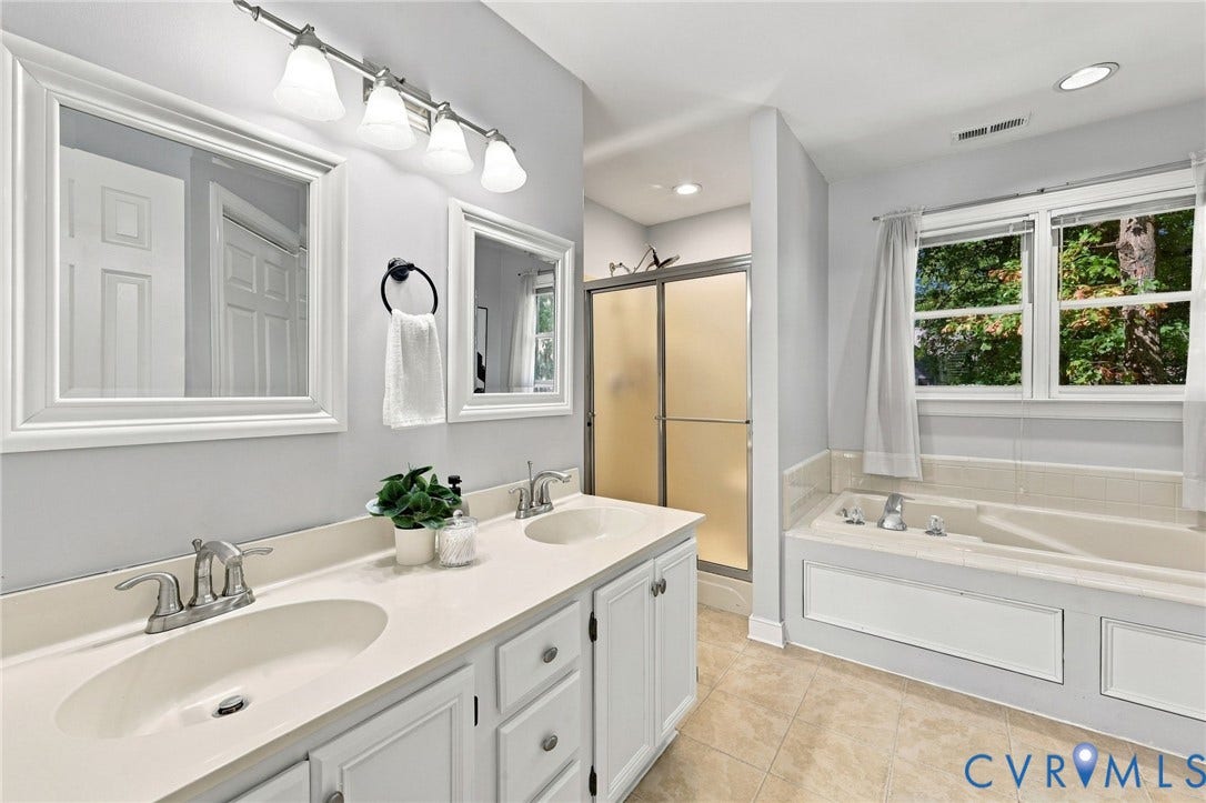 4712 Cedar Forest Road, Glen Allen, VA 23060 En-suite bathroom featuring a double-sink vanity, soaking tub, separate shower, and natural light.