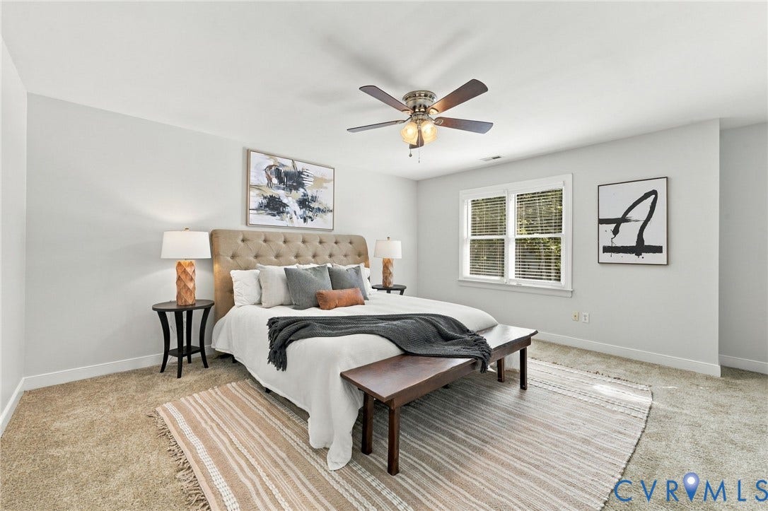 4712 Cedar Forest Road, Glen Allen, VA 23060 Spacious primary suite featuring neutral finishes, ceiling fan, and abundant natural light from double windows.