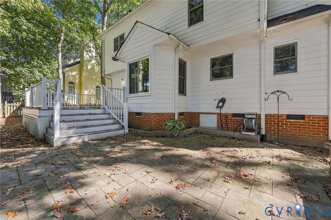 4712 Cedar Forest Road, Glen Allen, VA 23060 Spacious paver patio with easy access to the elevated deck, offering additional space for outdoor dining, entertaining, and relaxing.