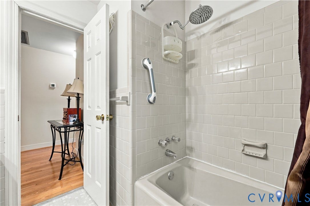 8307 Wallingford Lane, Chickahominy Bluffs, Henrico, VA 23227 Full-height ceramic tile surround, integrated soaking tub, chrome finish shower fixtures, and polished hardware