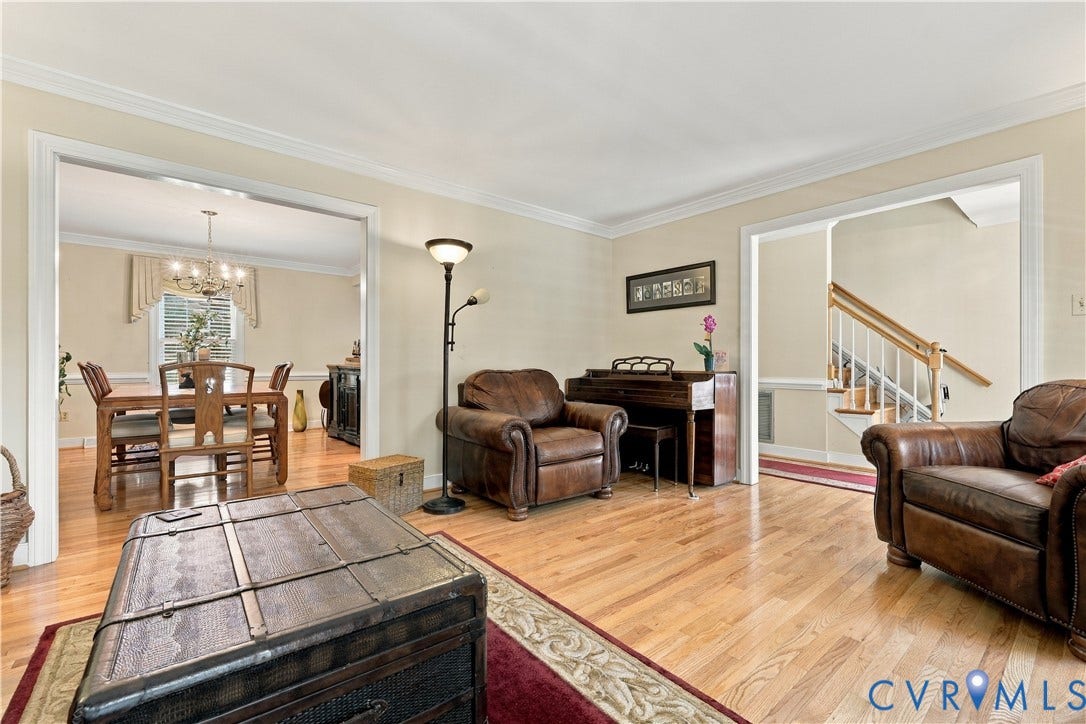 8307 Wallingford Lane, Chickahominy Bluffs, Henrico, VA 23227 Living space featuring wood-finish flooring, crown molding, and cased openings
