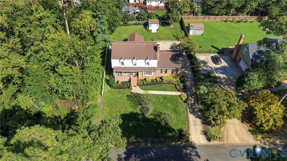 8307 Wallingford Lane, Chickahominy Bluffs, Henrico, VA 23227 Two-story colonial exterior featuring a brick and siding facade, a covered front porch, a multi-gabled roofline, and an expansive lawn with mature trees
