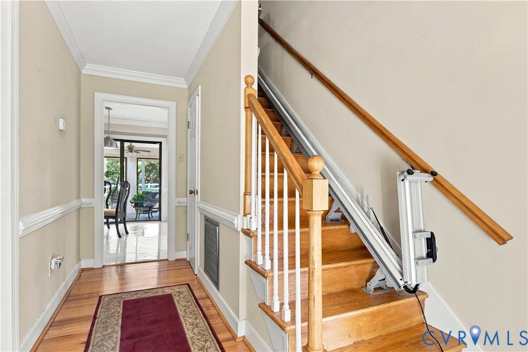 8307 Wallingford Lane, Chickahominy Bluffs, Henrico, VA 23227 Foyer featuring wood-finish flooring, staircase with a wood handrail, chair rail molding, and a mounted stair lift