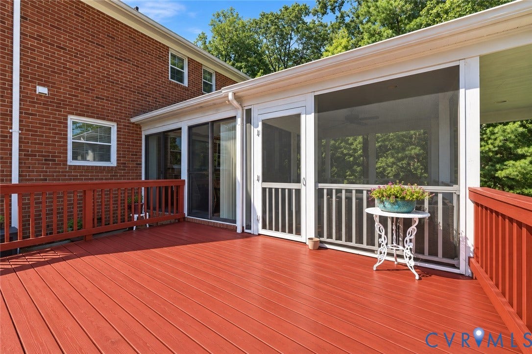 8307 Wallingford Lane, Chickahominy Bluffs, Henrico, VA 23227 Expansive deck with wood-finish decking and perimeter railing, featuring a screened-in porch with white framing and sliding glass door access