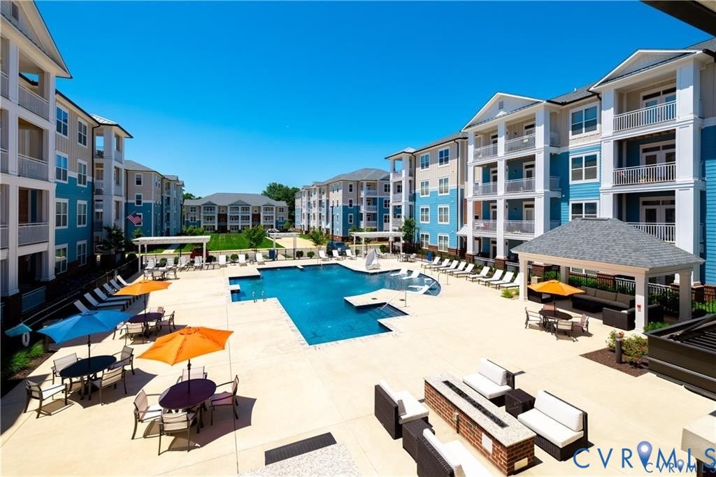 10525 Stony Bluff Drive, #107, Stony Run Condos, Ashland, VA 23005 Swimming pool with stone-finished decking, covered gazebo, built-in masonry fire pit, and multi-story structures featuring private balconies