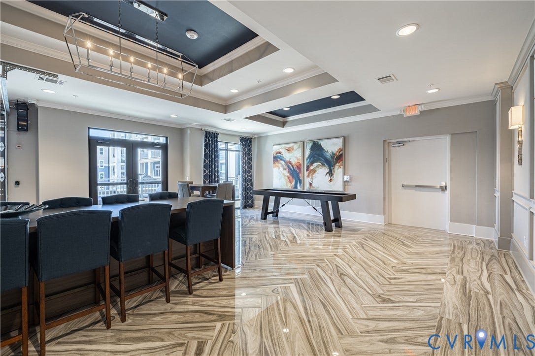 10525 Stony Bluff Drive, #107, Stony Run Condos, Ashland, VA 23005 Herringbone-patterned stone flooring, coffered ceilings with contrast paint, geometric metal pendant lighting, and recessed ceiling illumination