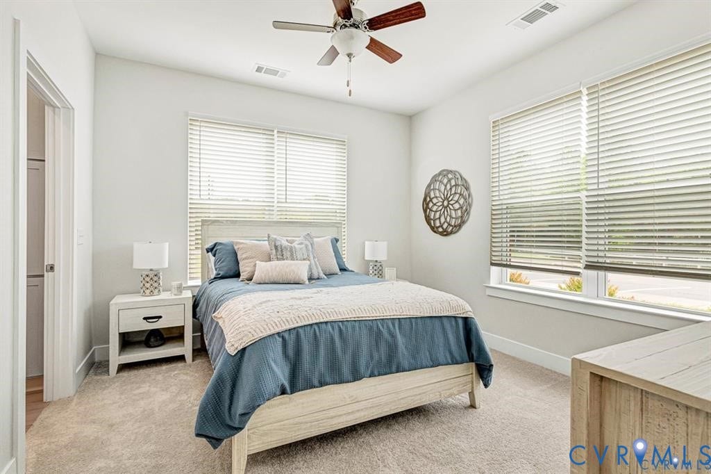 10525 Stony Bluff Drive, #107, Stony Run Condos, Ashland, VA 23005 Neutral-toned room featuring neutral carpeting, a ceiling fan with integrated lighting, dual windows with blinds, and light-toned wall finishes