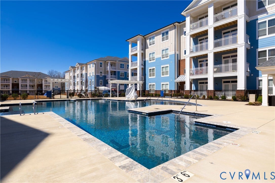 10525 Stony Bluff Drive, #107, Stony Run Condos, Ashland, VA 23005 Outdoor swimming pool featuring a stone-tile coping, concrete deck, metal handrails, and a dedicated spa area