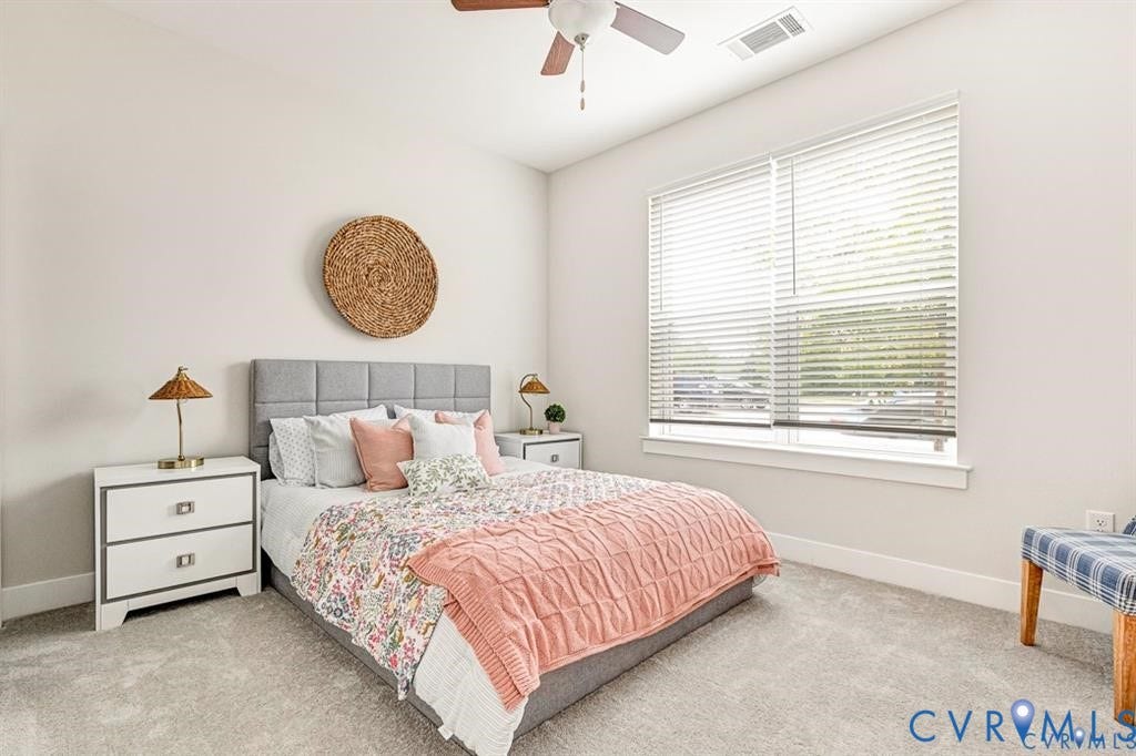 10525 Stony Bluff Drive, #107, Stony Run Condos, Ashland, VA 23005 Neutral-toned wall paint, large window with horizontal blinds, ceiling fan, and wall-to-wall carpeting