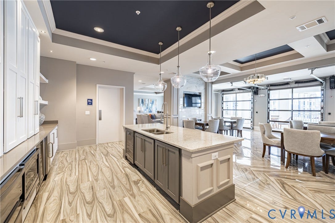 10525 Stony Bluff Drive, #107, Stony Run Condos, Ashland, VA 23005 Kitchen featuring a center island with stone countertops, white cabinetry with silver hardware, recessed ceiling lighting, glass pendant fixtures, and large-format tile flooring