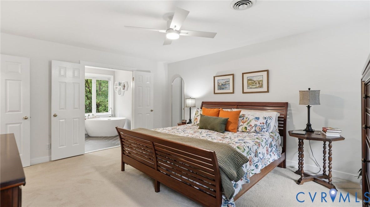 2040 Normandstone Drive, Roxshire, Midlothian, VA 23113 Bedroom featuring neutral carpeting, a white ceiling fan with integrated lighting, and double doors opening to a space containing a freestanding soaking tub