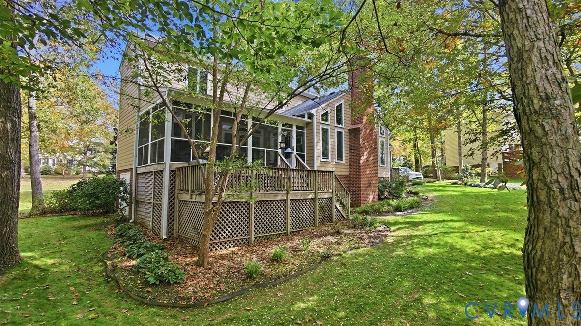 2040 Normandstone Drive, Roxshire, Midlothian, VA 23113 Rear exterior featuring a screened-in porch, multi-level wood deck, masonry chimney, and wood-siding facade