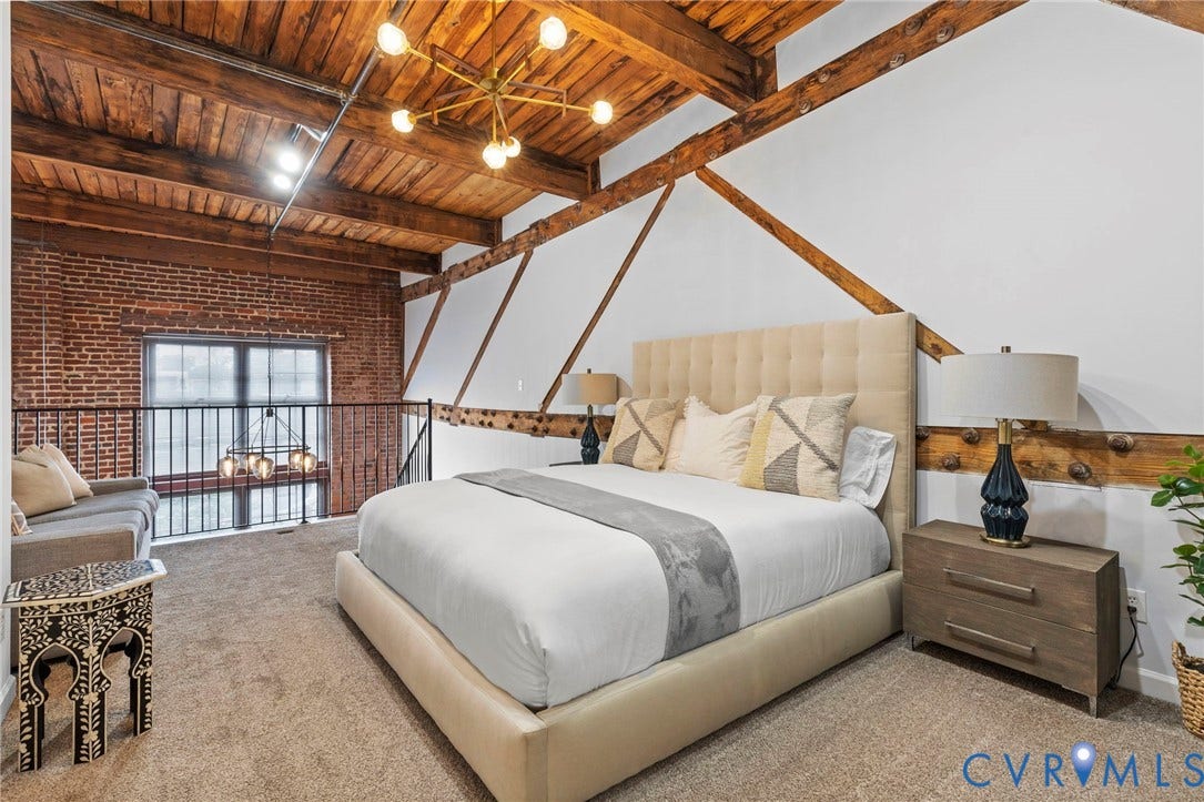 815 Porter Street, #U301, Richmond, VA 23224 Exposed brick wall, vaulted ceiling with heavy timber beams, metal railing, and decorative wall bracing
