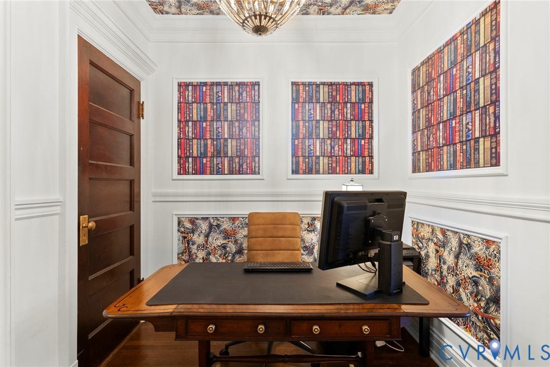 2416 Park Avenue, #U4, The Fan District, Richmond, VA 23220 Wood-finish door with brass hardware, wall molding with patterned wallpaper insets, crown molding, ceiling-mounted statement light fixture, and wood-finish flooring