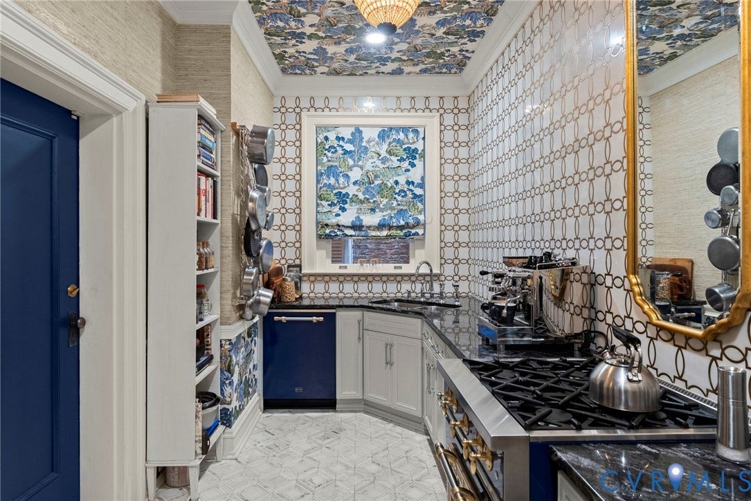 2416 Park Avenue, #U4, The Fan District, Richmond, VA 23220 Kitchen featuring patterned tile walls, geometric stone flooring, integrated blue dishwasher, stainless steel gas range, and built-in shelving