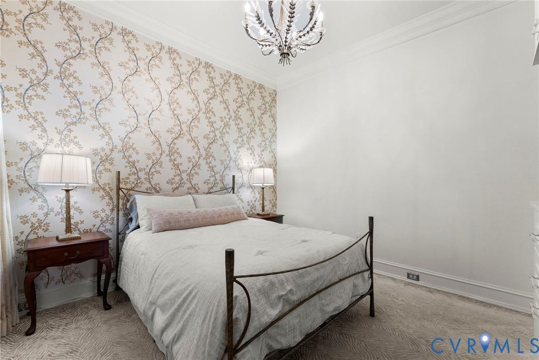 2416 Park Avenue, #U4, The Fan District, Richmond, VA 23220 Room featuring an accent wall with floral patterned wallpaper, crown molding, and a decorative multi-arm chandelier