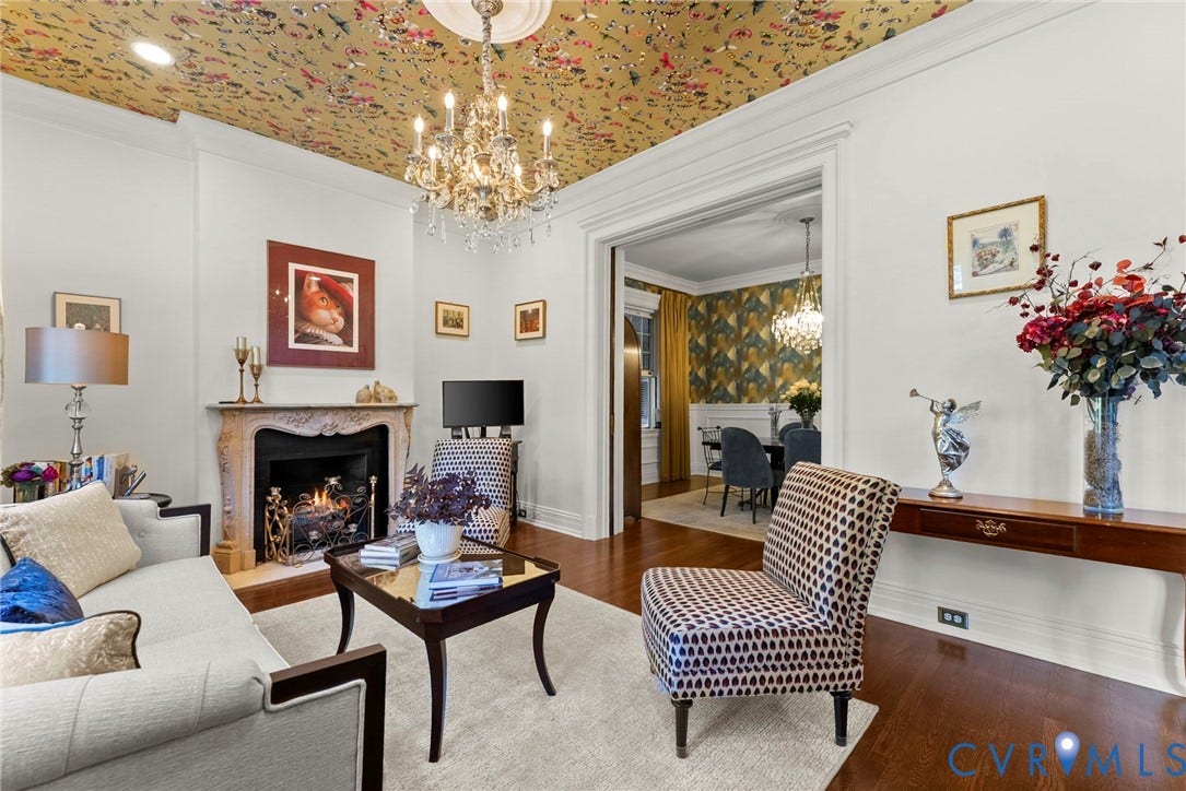 2416 Park Avenue, #U4, The Fan District, Richmond, VA 23220 Carved stone fireplace mantle, ceiling medallion, crystal chandelier, floral-patterned ceiling treatment, and wood-finish flooring