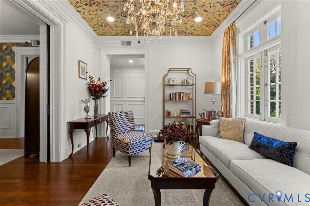 2416 Park Avenue, #U4, The Fan District, Richmond, VA 23220 Interior space featuring patterned ceiling treatment, crystal chandelier, wood-finish flooring, multi-pane windows with grid detailing, and extensive wall molding