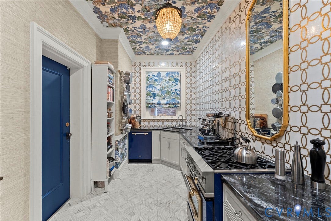 2416 Park Avenue, #U4, The Fan District, Richmond, VA 23220 Kitchen featuring stone countertops, geometric patterned tile walls, built-in cabinetry, an integrated dishwasher, and a crystal chandelier fixture