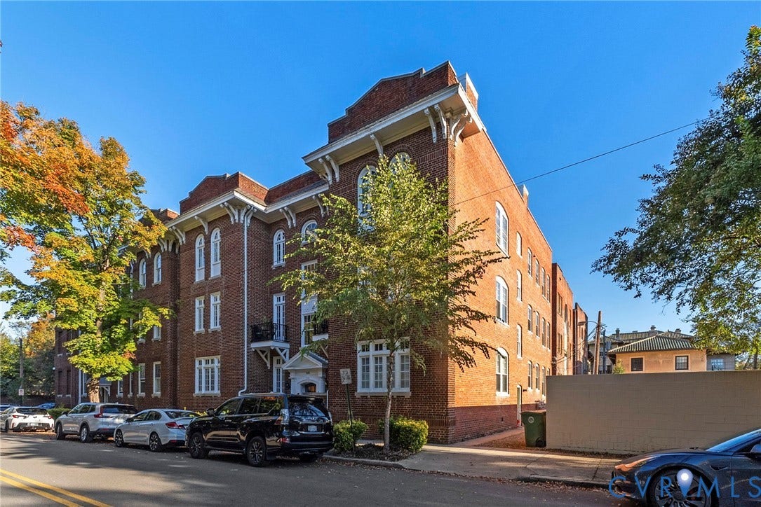 2416 Park Avenue, #U4, The Fan District, Richmond, VA 23220 Multi-story brick exterior featuring ornate corbelled cornices, arched window detailing, wrought iron balconies, and a decorative roofline parapet