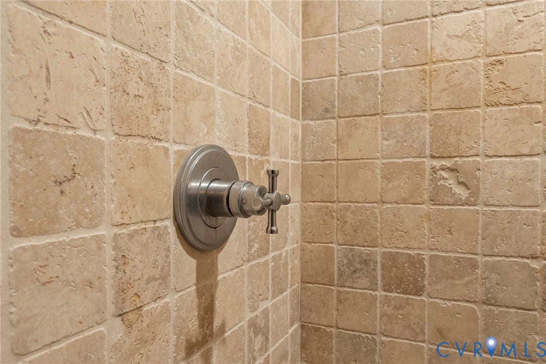 2416 Park Avenue, #U4, The Fan District, Richmond, VA 23220 Shower surround featuring square-cut natural stone tile and a metallic single-handle control valve
