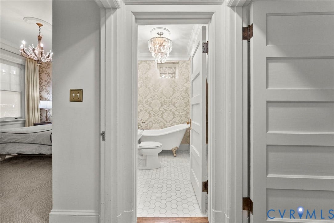 2416 Park Avenue, #U4, The Fan District, Richmond, VA 23220 Bathroom featuring a clawfoot soaking tub, patterned wallpaper, crystal-style chandelier, and white hexagonal tile flooring