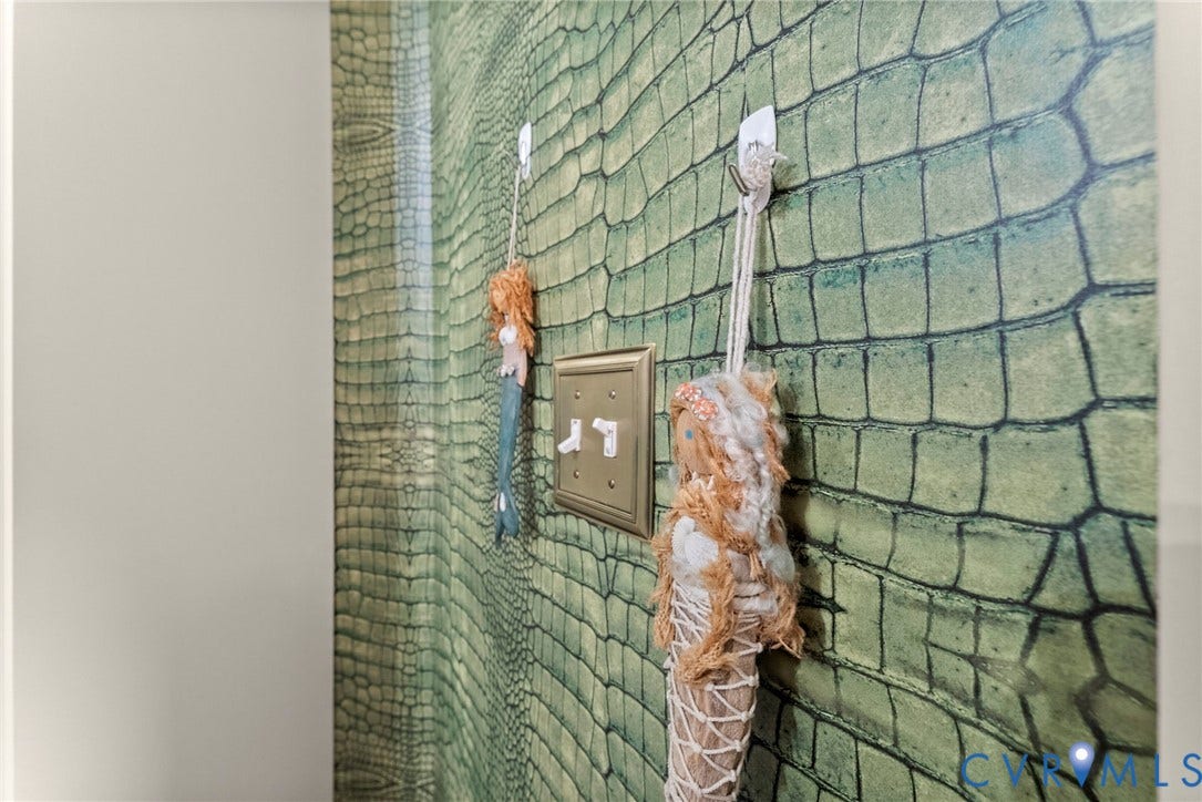 2416 Park Avenue, #U4, The Fan District, Richmond, VA 23220 Textured green alligator-patterned wallpaper accented by a metallic-finish double toggle light switch plate