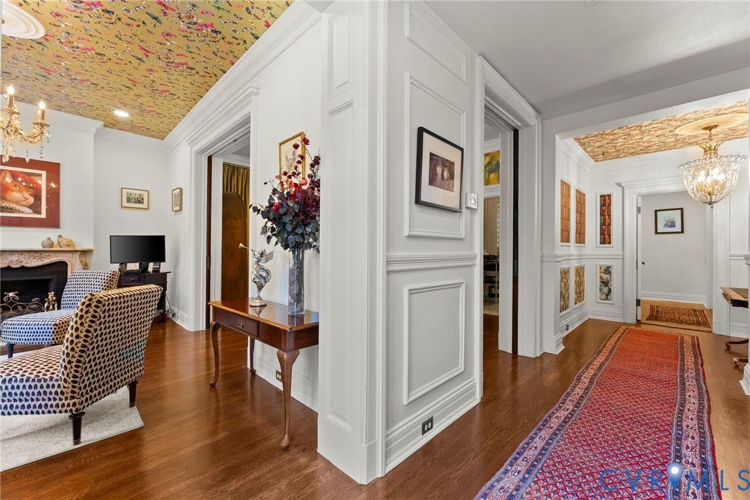 2416 Park Avenue, #U4, The Fan District, Richmond, VA 23220 Intricate ceiling wallpaper, ornate crystal chandeliers, wall wainscoting, decorative fireplace mantle, and wood-finish flooring