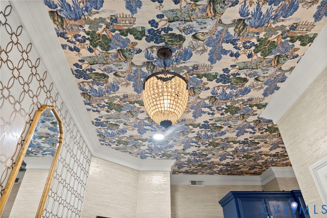2416 Park Avenue, #U4, The Fan District, Richmond, VA 23220 Intricate patterned ceiling wallpaper, multi-tiered beaded chandelier, textured wall coverings, crown molding, and geometric-patterned wall accent