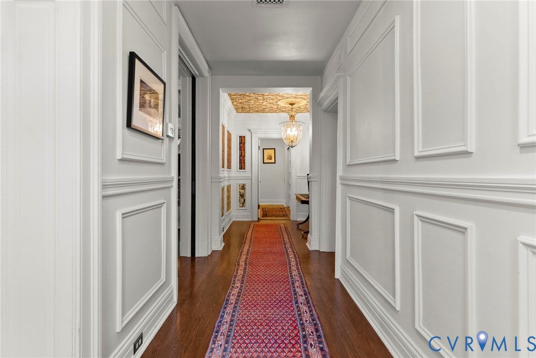 2416 Park Avenue, #U4, The Fan District, Richmond, VA 23220 Hallway featuring extensive wainscoting and molding, wood-finish flooring, decorative ceiling pattern, and a central crystal chandelier