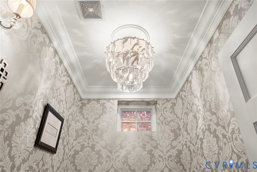 2416 Park Avenue, #U4, The Fan District, Richmond, VA 23220 Tiered crystal chandelier with a ceiling medallion, crown molding, and patterned wallpaper