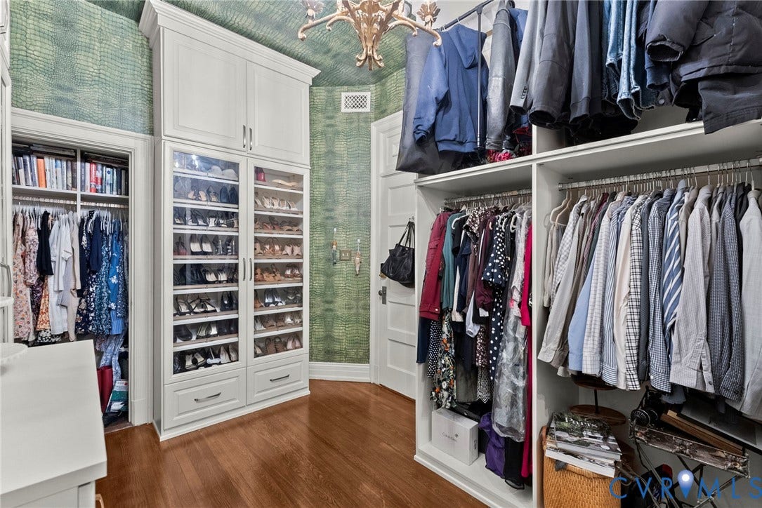 2416 Park Avenue, #U4, The Fan District, Richmond, VA 23220 Custom dressing room featuring floor-to-ceiling cabinetry, glass-front shelving, integrated storage drawers, and wood-finish flooring