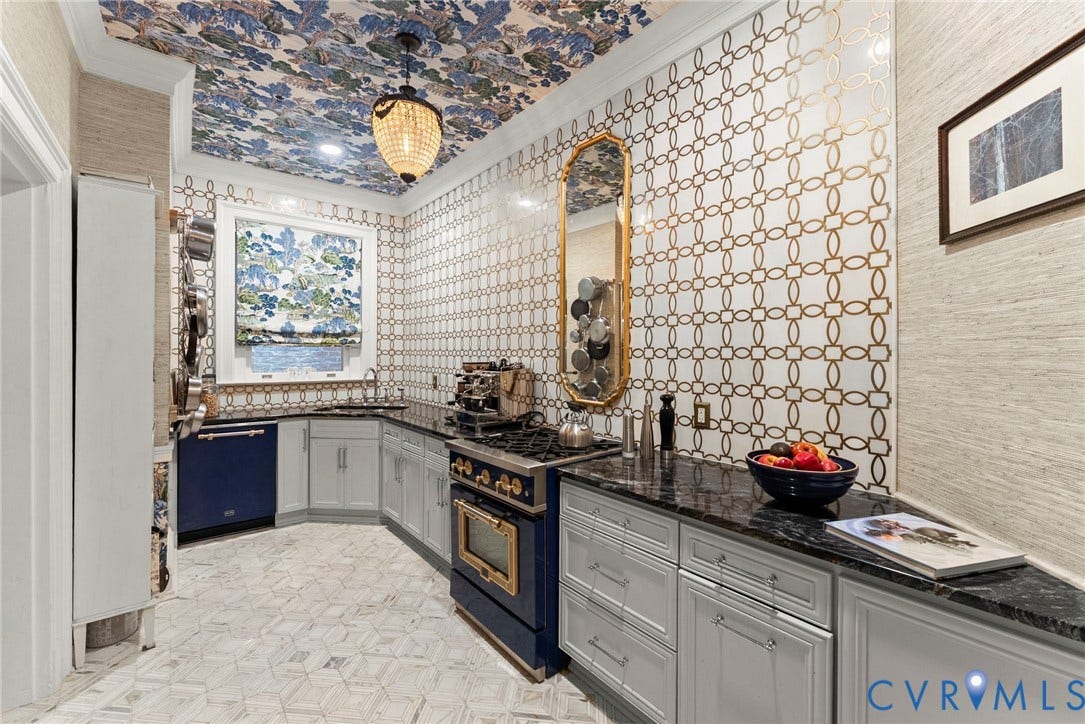 2416 Park Avenue, #U4, The Fan District, Richmond, VA 23220 Kitchen featuring patterned wall tile, custom cabinetry, dark stone countertops, natural stone geometric floor tile, and integrated appliance suite