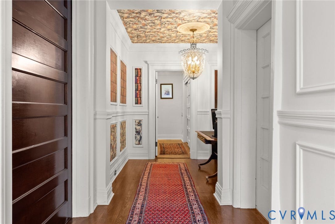 2416 Park Avenue, #U4, The Fan District, Richmond, VA 23220 Entryway featuring wall wainscoting, a detailed ceiling medallion, a decorative hanging pendant light, custom wallpapered ceiling, and dark wood-finish flooring