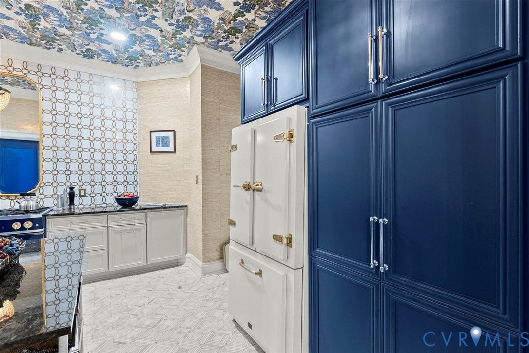 2416 Park Avenue, #U4, The Fan District, Richmond, VA 23220 Custom navy blue cabinetry, integrated appliance featuring metallic latches, patterned tile backsplash, textured wall covering, and floral-motif ceiling finish