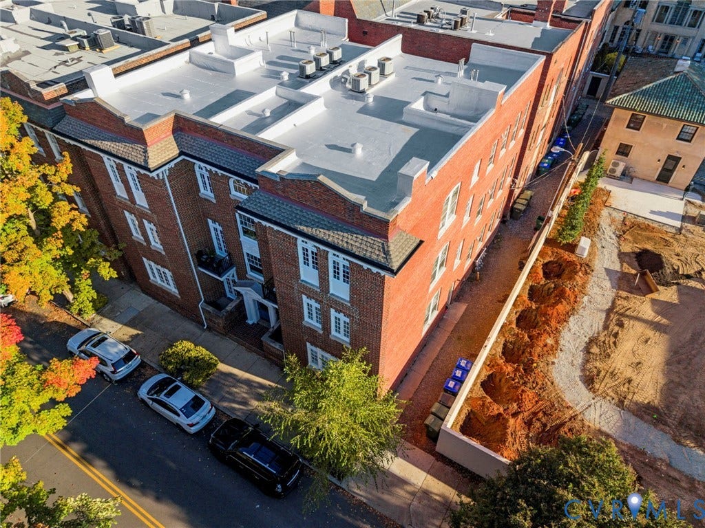2416 Park Avenue, #U4, The Fan District, Richmond, VA 23220 Multi-story brick exterior featuring decorative cornice detailing, individual balconies, and a flat roofline