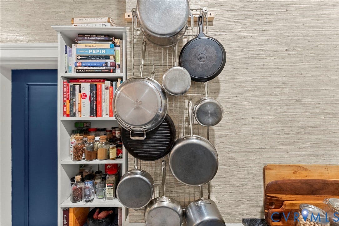 2416 Park Avenue, #U4, The Fan District, Richmond, VA 23220 Built-in floor-to-ceiling white shelving unit featuring adjustable storage partitions and wall-mounted metal rack system for hanging cookware