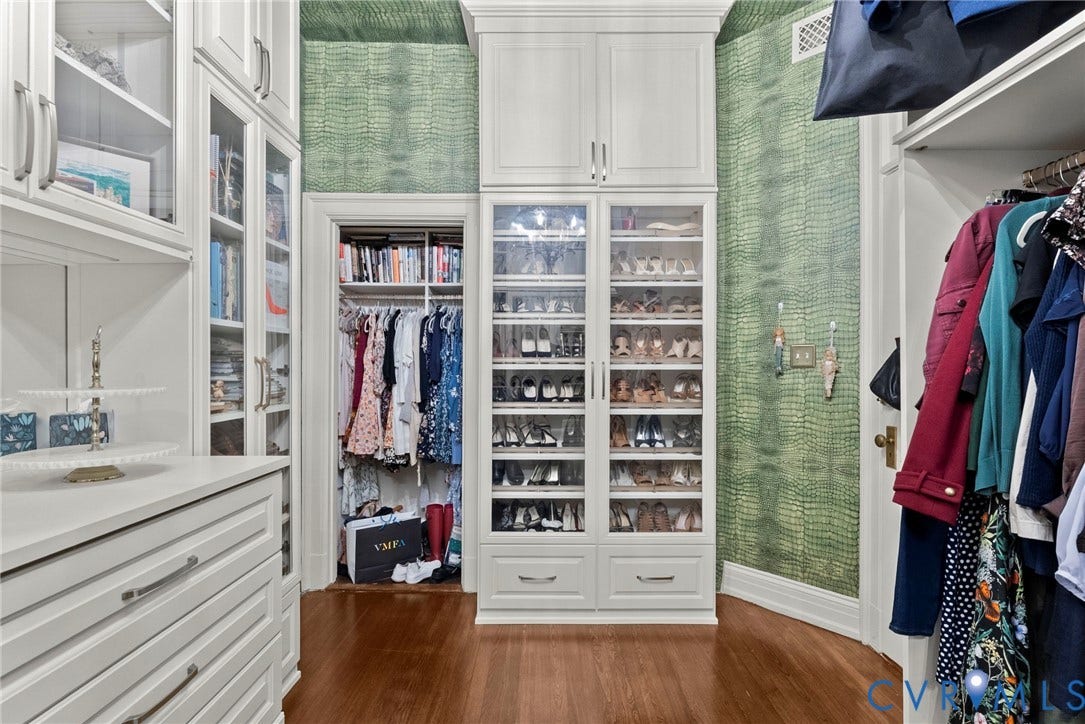 2416 Park Avenue, #U4, The Fan District, Richmond, VA 23220 Custom-built cabinetry featuring floor-to-ceiling glass-front doors, integrated upper storage units, extensive built-in shelving, and hardwood flooring