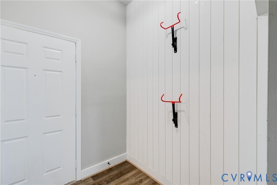 620 Chimborazo Boulevard, Church Hill, Richmond, VA 23223 Interior space featuring wood-finish flooring, vertical shiplap wall paneling, and two wall-mounted metal hooks