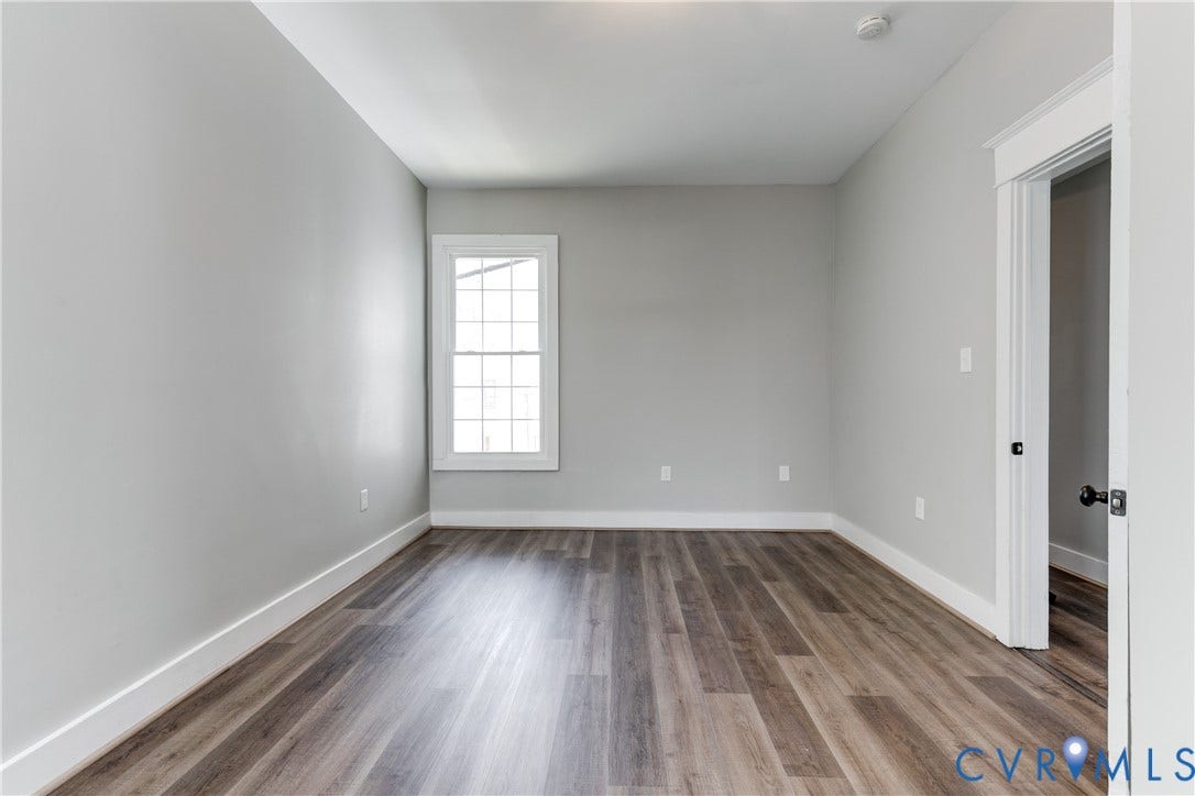 620 Chimborazo Boulevard, Church Hill, Richmond, VA 23223 Neutral-toned interior featuring wood-finish flooring, white door casing, and a multi-pane window
