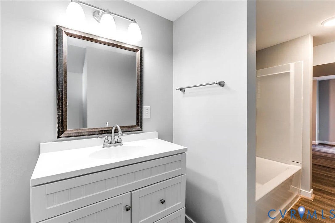 620 Chimborazo Boulevard, Church Hill, Richmond, VA 23223 Bathroom vanity with a white countertop, integrated sink, shaker-style cabinetry, and a three-light vanity fixture
