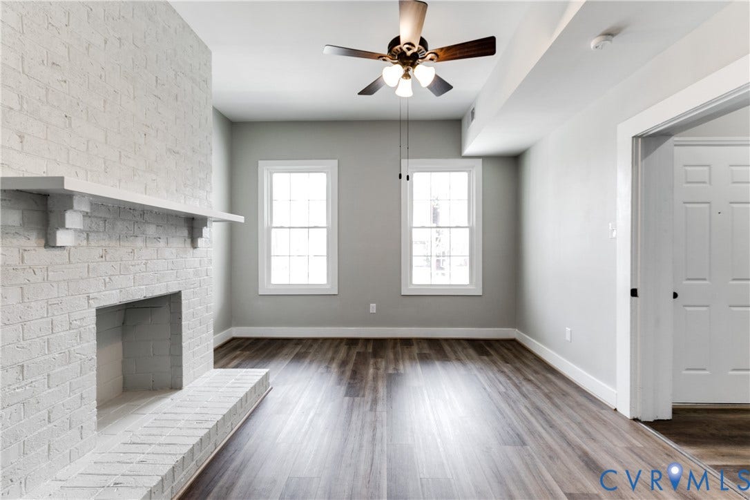 620 Chimborazo Boulevard, Church Hill, Richmond, VA 23223 Painted brick fireplace with a mantle, wood-finish flooring, and a multi-light ceiling fan