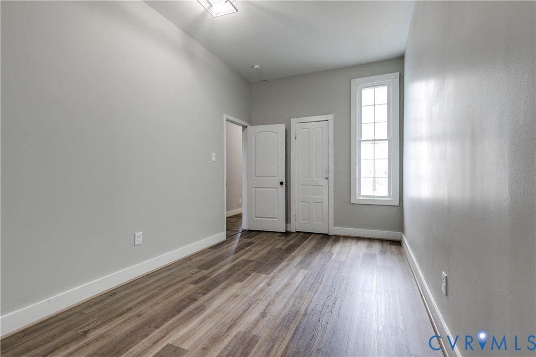 620 Chimborazo Boulevard, Church Hill, Richmond, VA 23223 Interior space featuring wood-finish flooring, a tall multi-pane window, and two paneled interior doors