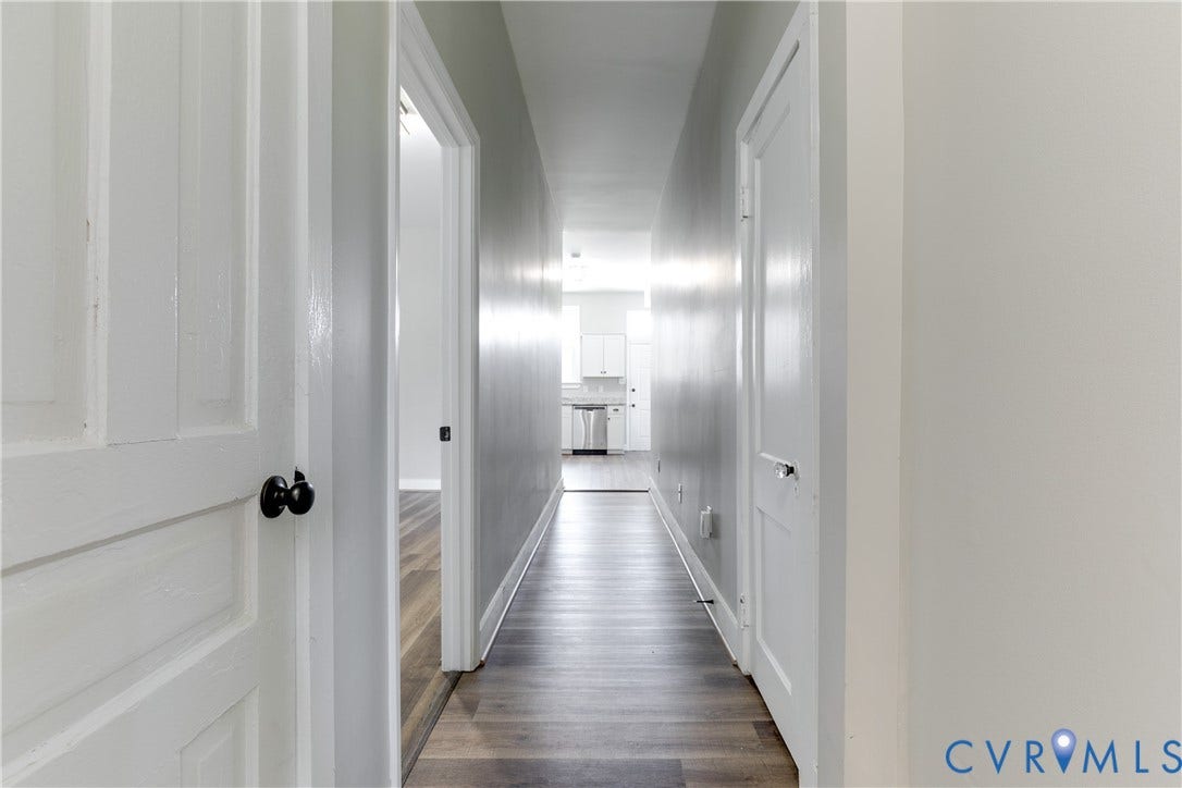 620 Chimborazo Boulevard, Church Hill, Richmond, VA 23223 Hallway featuring wood-finish flooring, white five-panel interior doors, and matte black hardware