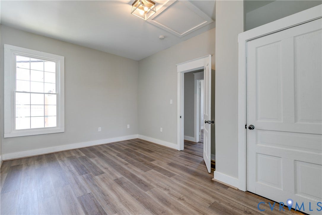 620 Chimborazo Boulevard, Church Hill, Richmond, VA 23223 Neutral-toned room featuring wood-finish flooring, a multi-pane window, flush-mount light fixture, and a two-panel interior door